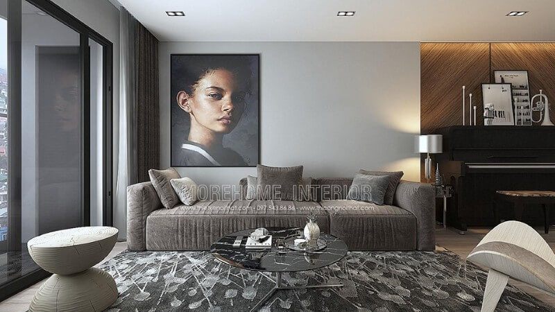 Chiếc sofa dài bằng nỉ màu xám kết hợp chiếc bàn trà màu đen đặt trên chiếc thảm màu xám trắng mang đến không gian mát mẻ